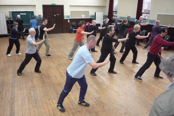 A class of students practising the hand form